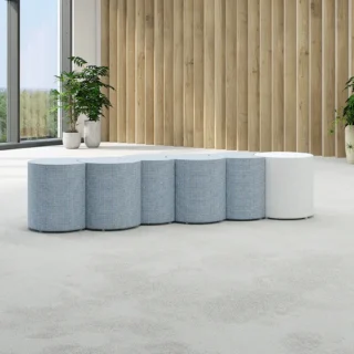 Picture shows Flexxform Mae in a serpentine shape with 5 Wax ottomans and 1 Rio ottoman. Grey and White fabric are shown.