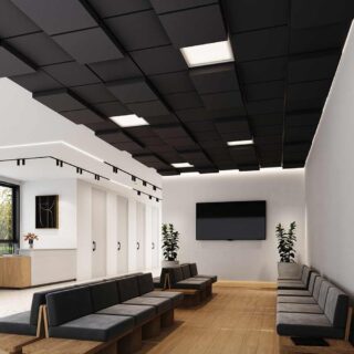 A modern waiting room with a suspended ceiling of black Ezobord Kubica acoustic tiles, providing sound absorption and a stylish aesthetic.