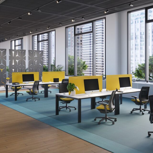 Modern office interior featuring Ezobord desk screens in a vibrant yellow color, creating a stylish and functional workspace.