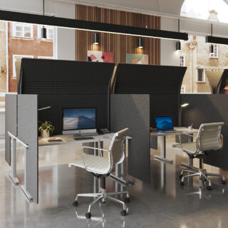 Ezobord Hoody sound-absorbing panels create private workspaces in an open-plan office. The panels feature a unique, curved design and are customizable to suit various office layouts.