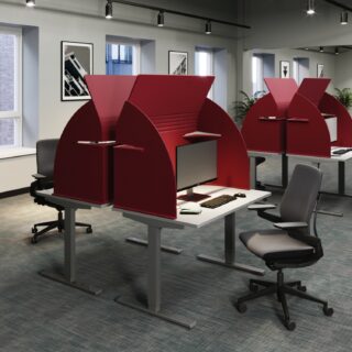 Red acoustic desk dividers with storage shelves, providing a private and functional workspace.