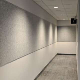 Gray Ezobord Tac Panels installed on a hallway wall, providing sound absorption and noise reduction.