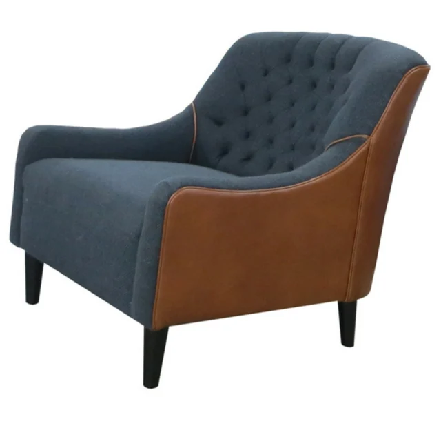 TLS By Design lounge chair, blue tufted fabric upholstery with tan leather side panels and dark wood legs.