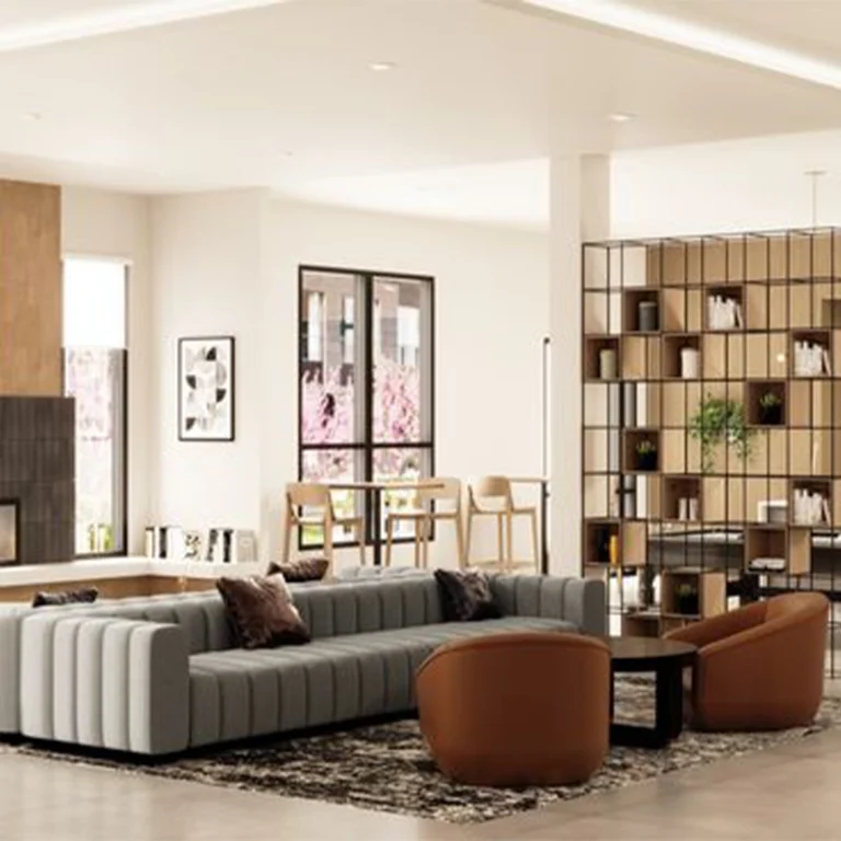 TLS by Design custom furniture in a modern hotel lobby: gray sectional sofa, brown leather armchairs, black coffee table, and open bookshelf.